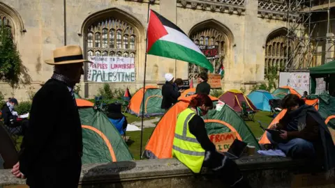 Getty Images Protesters camped outside King's College in Cambridge