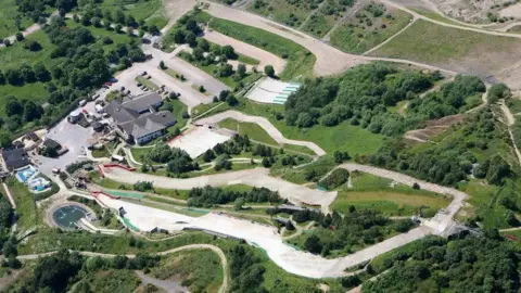 An aerial view of Sheffield's dry ski slope, which shows white slopes winding down a hill