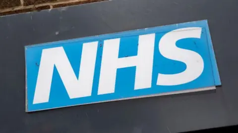 Close up of the NHS logo, the white lettering on a blue background