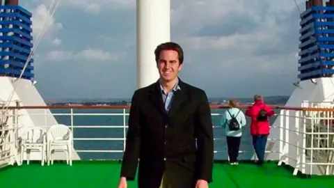 George Holland George Holland standing on the deck at the rear of the ship