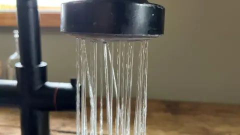 Water runs out of a kitchen tap