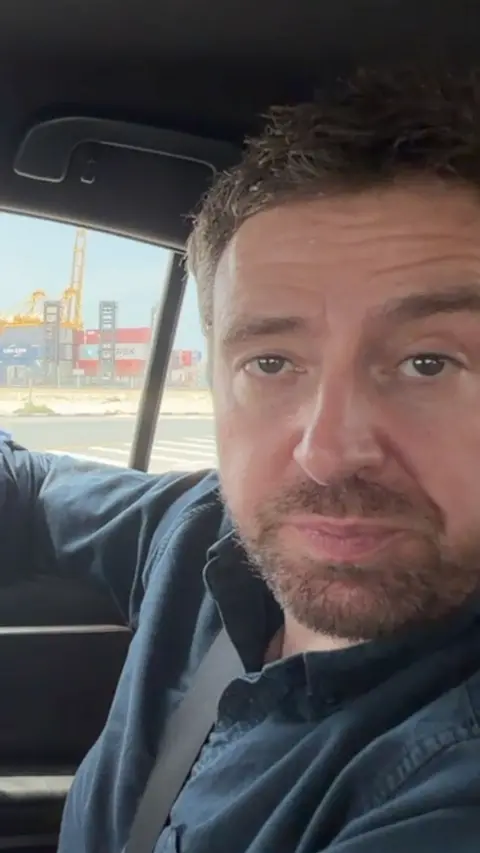 Nick Beake in a car at Dubai port