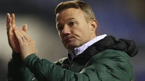 Reading manager Noel Hunt applauds the club's fans