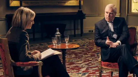 Andrew Mountbatten-Windsor sits in a suit, being interview by Emily Maitlis