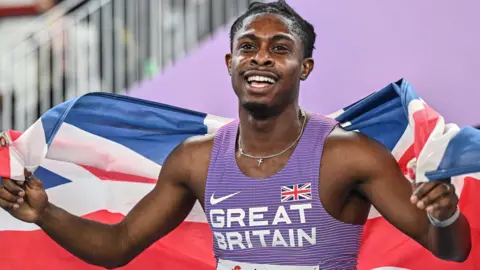 Great Britain's Jeremiah Azu celebrates winning world indoor 60m gold