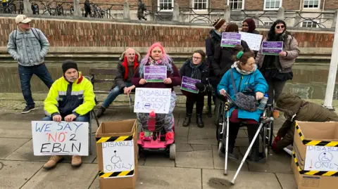 A group of protestors outside Bristol City Hall who are against the LTN