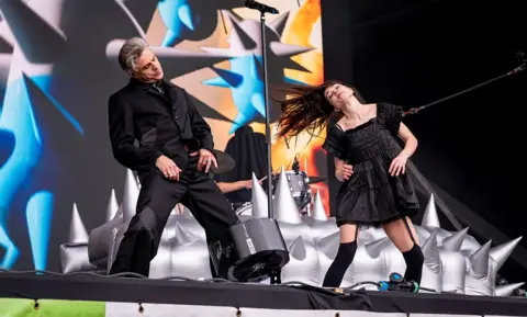 Janet Planet (right) and Sugar Bones of Confidence Man, sporting matching all black outfits on stage at Worthy Farm