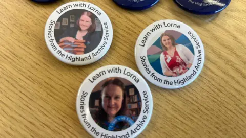Woman's face on white badge