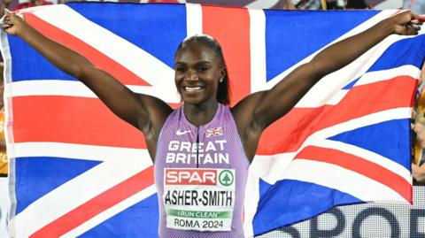 Dina Asher-Smith celebrates after winning European 100m gold