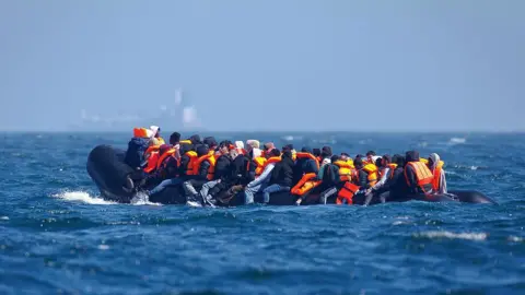 A large group of people piled onto a dingy. 