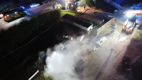 Dan Jessup An aerial view shows smoke coming from the site