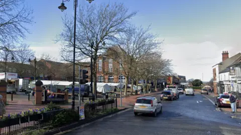 Google Streetview image of Ripley market place, showing stalls, the main street and shops