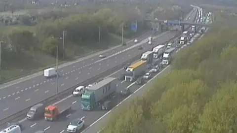 M1 Junction 20 is pictured, with queueing traffic on one side of the road