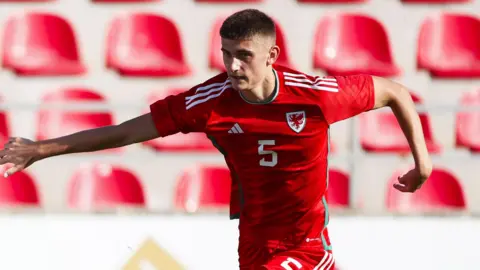 Daniel Cox playing for Wales Under-19s