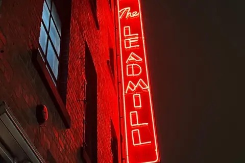 A red luminous fascia sign which reads The Leadmill