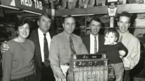 Irish Clothing Company A black-and-white image of six members of the Brown family who have run the business since 1910