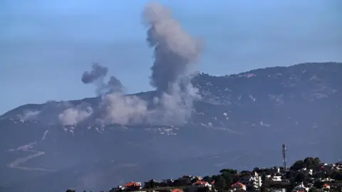 EPA Smoke rises over the mountains following an Israeli airstrike in southern Lebanon, as seen from the Israeli side of the border in the Upper Galilee, northern Israe