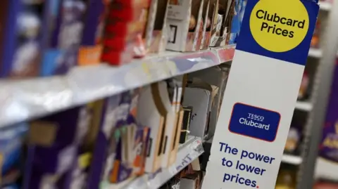Clubcard branding is seen inside a branch of a Tesco Extra Supermarket in London,