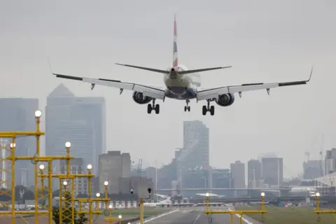 Bloomberg/Getty Images A plane lands at a London airport.