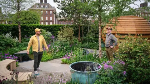 Julie Skelton Designers Nick and Duncan look around their beautiful garden and admire the views.