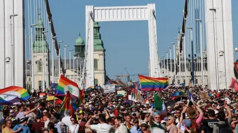 Crowd on Elisabeth Bridge in Budapest, waving rainbow flags