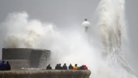 Waves crash over the seafront in Porthcawl in Wales