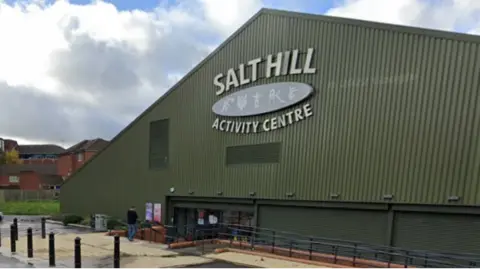 A general view picture of the Salt Hill Activity Centre, which is a large, green building made from corrugated metal.