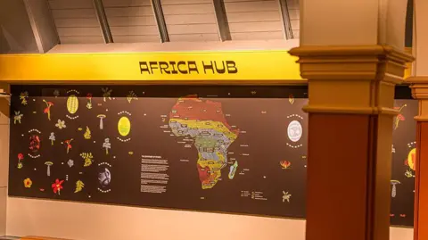 Manchester Museum handout A display featuring the map of Africa with the sign Africa Hub in the Manchester Museum. 