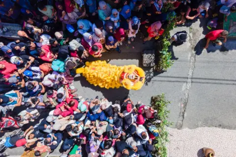 Chaideer Mahyuddin/AFP An aerial picture shows dancers performing the Lion Dance in Banda Aceh 
