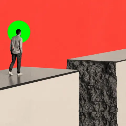 BBC A person standing on a path which is crumbling