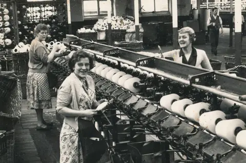 Belper Historical Society Three women in a black and white image on a factory line.