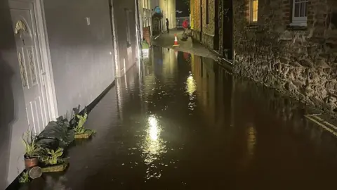Andrew Wallbank Flooding in Lostwithiel There is flood defences against a door on the left. 