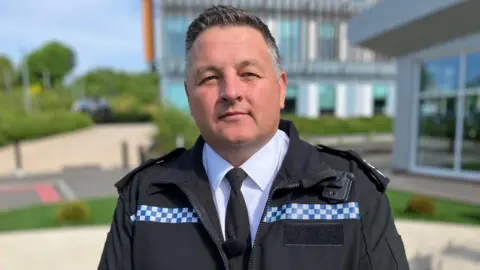 Chief Superintendent Stephen Jones, from South Wales Police is wearing his police uniform and looking straight at the camera.