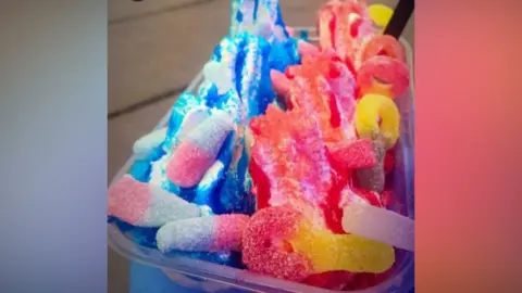 Mr Shuey A fizz bomb and sherbert ice cream in blue and red sauces and fizz bottles,