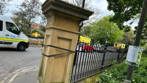 A stone pillar tied to a railing in Leazes Park to stop it from falling