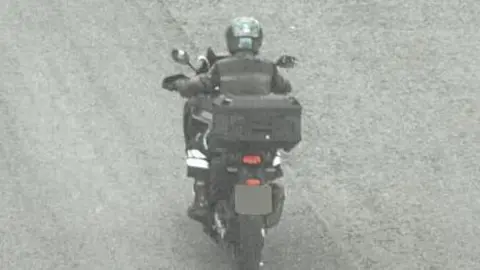 Leicestershire Police The rear view of a motorbike being ridden by Guy Martin as taken from a traffic camera. The number plate has been blurred.