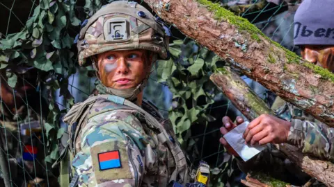 A female British soldier of a gun battery attends the Allied Spirit 25 exercise in Hohenfels, Germany, 12 March 2025
