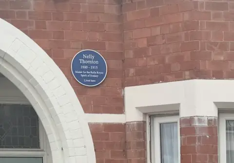 Leamington Town Council A blue plaque on a red brick building reads: Nelly Thornton, 1880-1915. Model for the Rolls-Royce Spirit of Ecstasy lived here