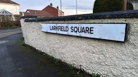 A street sign saying Larkfield Square on it.