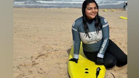 Daniela,17, from El Salvador with a surfing board