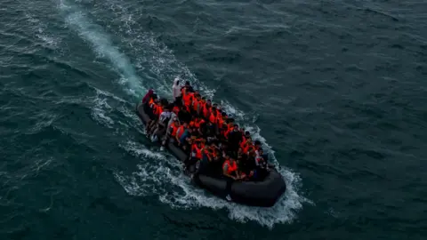 Reuters A drone shot of a crowded dinghy, full of people in life vests