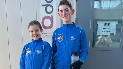 Suzanne Otterson-MacDonald Isla, left, and Lewis, in there bright blue tracksuit tops, pose for a photo outside the dressing room door at one of the show venues.