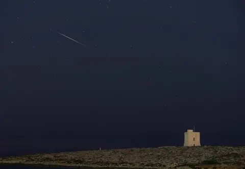 Reuters A meteor streaks through the night sky behind St Mark's Tower in Malta