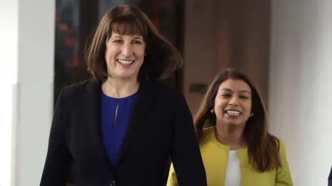 Reuters Tulip Siddiq (right) walks with Chancellor Rachel Reeves at the Labour Party autumn conference