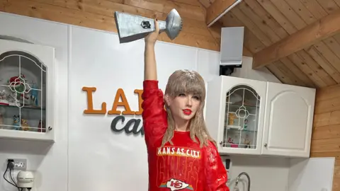 The life-size Taylor Swift cake, with decorations including a Kansas City shirt and the Super Bowl trophy