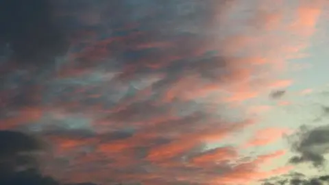 Navigatio/BBC pink clouds in the sky as sunsets 