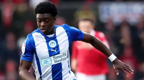 Michael Olakigbe in action for Wigan Athletic