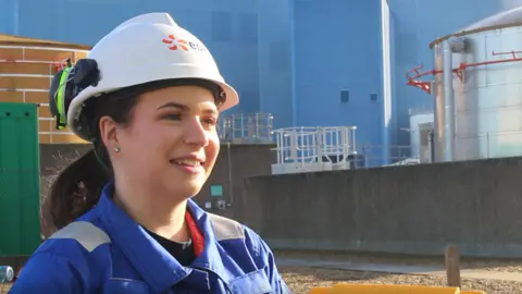 George King/BBC Jessica Willett - a Sizewell B employee wearing a hard hat looking just past the camera