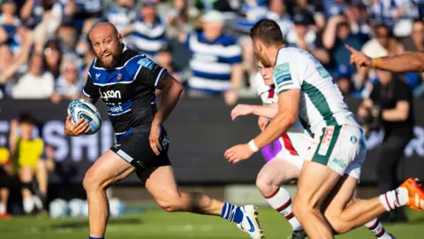 Tom Dunn (left) runs with the ball to score Bath's fourth try