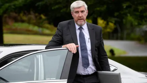 PA Infrastructure minister John O'Dowd getting out of a car.